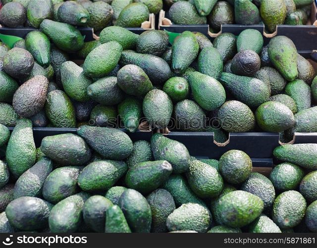 A large selection of avocados in boxes at a vegetale market