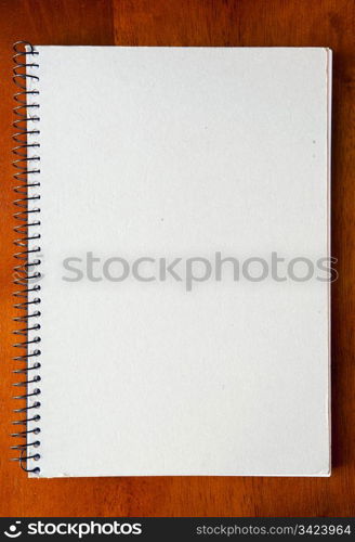 A large spiral bound notebook with blank pages