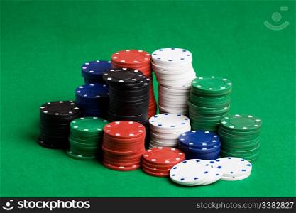 A large stack of poker chips on a green felt