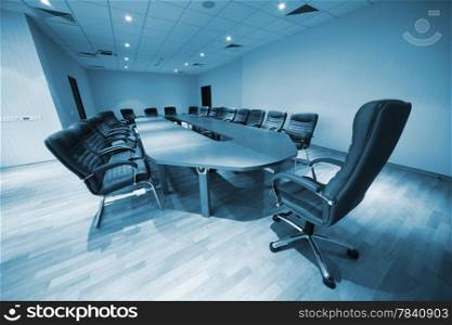 a large table and chairs in a modern conference room