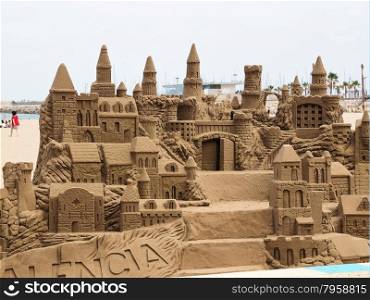 A lavish and large sand castle on an empty beach.