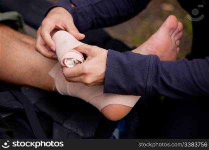 A leg tensor bandage being applied outdoors