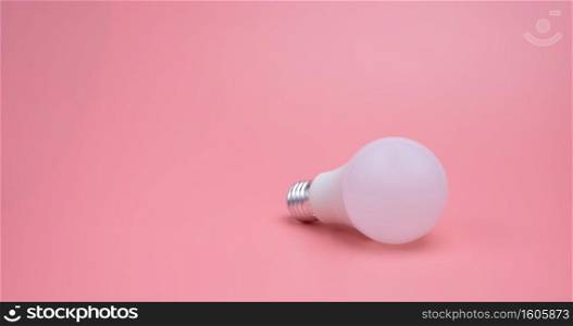 A light bulb in the pink background , New idea concept