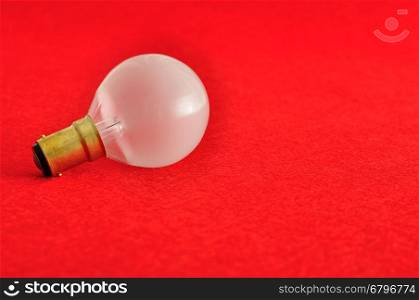 A light bulb isolated on a red background