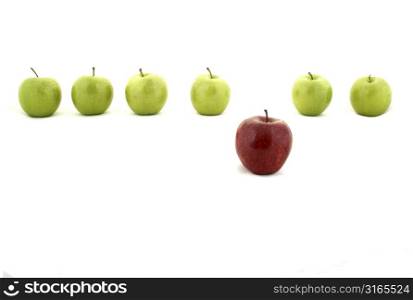 A line of green apples and one red apple