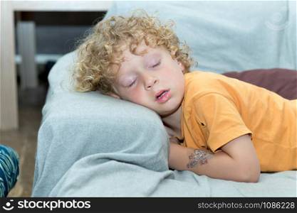 a little boy sleeping on the sofa