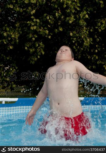 A little boy swimming in a pool.. Boy Swimming