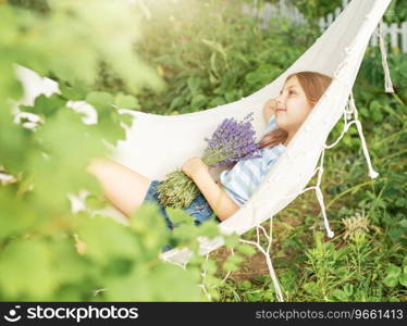 A little girl rests in a hammock  in the summer.  Summer in the village. 