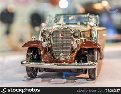 A little model of classic car on bokeh background