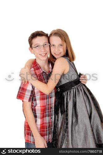 A little sister is hugging her older brother, isolated on white background.