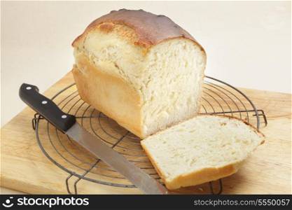 A loaf of freshly-baked homemade bread with the end cut from it to show the texture