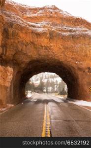 A lone pedestrian crosses the road past Red Canyon road tunnel