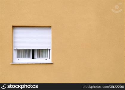 A lone window in a yellow wall.