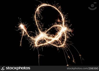A long exposure shot of light painted shapes with a sparkler at night.