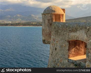 A lookout tower overlooking Calvi bay and mountains beyond from Calvi citadel in Corsica