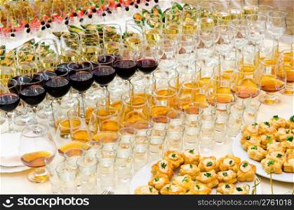 a lot of alcohol drinks on buffet table, catering
