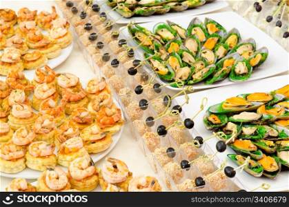 a lot of cold snacks on buffet table, catering