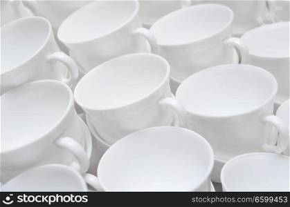 a lot of empty white tea cups