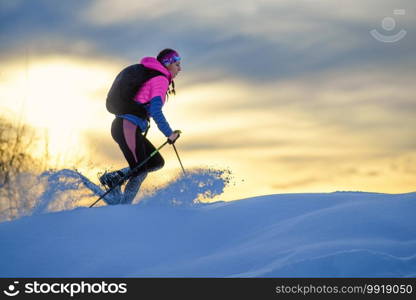 A lot of fresh snow that moves where a girl with snowshoes passes