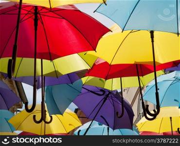 a lot of open multicolored umbrellas, street decoration