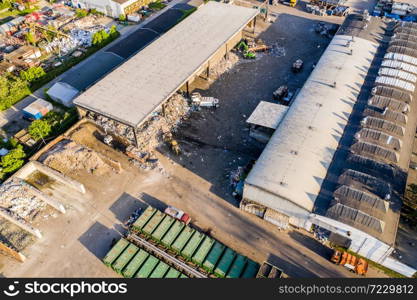 A lot of waste is disposed of in the waste disposal pits. Loaders is working on a mountain garbage. Aerial view and top view.