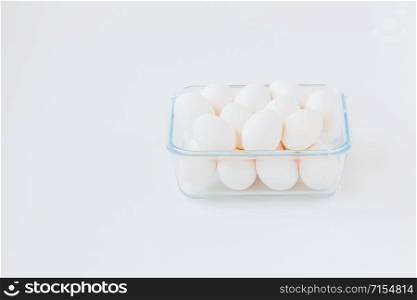 A lot of white eggs in a glass bowl. During cooking in the kitchen, the ingredients.. A lot of white eggs in a glass bowl.