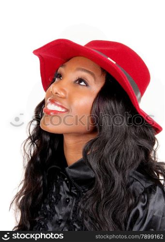 A lovely African American woman in a black blouse and long black curlyhair with a red hat looking up, isolated for white background.