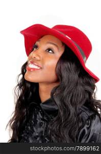A lovely African American woman in a black blouse and long black curlyhair with a red hat looking up, isolated for white background.