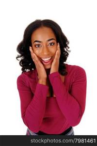 A lovely African American woman with long curly black hair holding herhands on her face, smiling, isolated for white background.