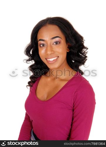 A lovely African American woman with long curly black hair smilingin a portrait image, isolated for white background.