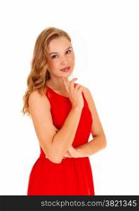 A lovely beautiful young woman standing in a red dress, looking into thecamera, isolated for white background.
