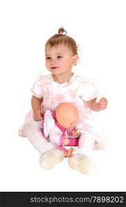 A lovely blond baby girl sitting on the floor holding her biscuits and playingwith her dolly, isolated for white background.