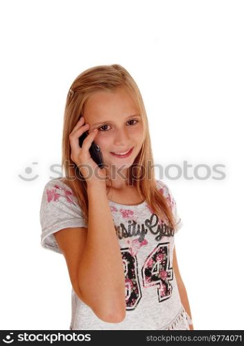 A lovely blond young girl standing for white background holding herhands on her chicks and smiling.