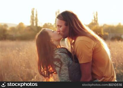 A lovely couple kissing under the sun