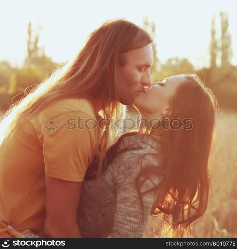 A lovely couple kissing under the sun