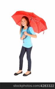 A lovely little girl in jeans standing isolated for white background holdinga red umbrella.