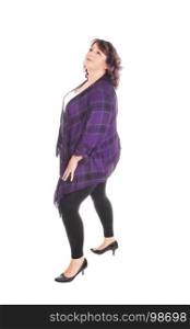 A lovely overweight woman in her forties standing in profile in tights,looking up, isolated for white background