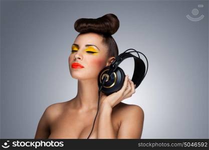 A lovely photo of beautiful girl holding headphones in her hand.