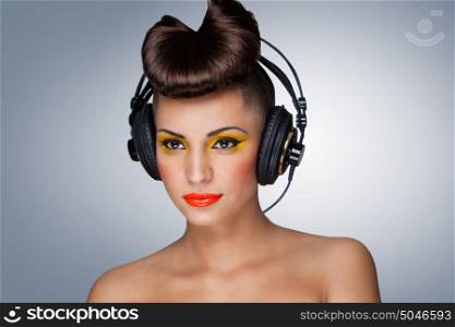 A lovely photo of beautiful girl holding headphones in her hand.