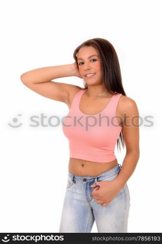 A lovely picture of a young pretty teen girl standing in jeans and a pinktop, smiling, isolated on white background.