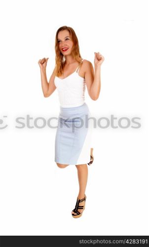 A lovely slim woman in a blue and white skirt and a white top standingisolated for white background and dancing.