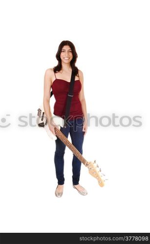 A lovely slim woman standing in jeans and a burgundy t-shirt, holdingher guitar and smiling, isolated on white background.