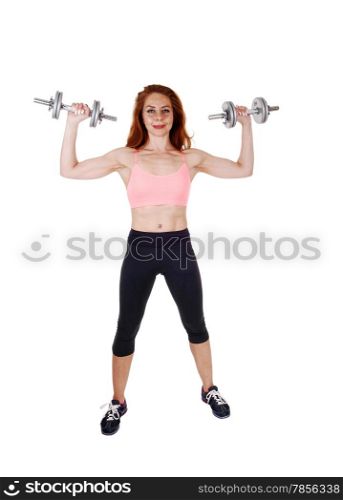 A lovely slim women in black exercise pants and sports bra workingout with dumbbell&rsquo;s, isolated on white background.