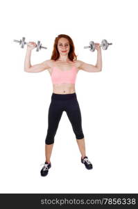 A lovely slim women in black exercise pants and sports bra workingout with dumbbell&rsquo;s, isolated on white background.