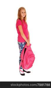 A lovely slim young girl with her backpack in her hand standing for whitebackground, smiling and ready to go to school.