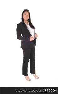 A lovely smiling Asian business woman standing in a portrait image in a black business suit and white blouse, isolated for white background