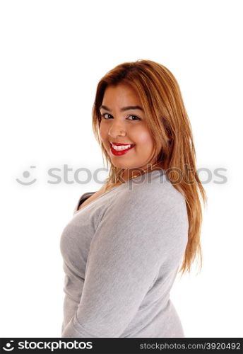A lovely smiling young Asian woman in a gray dress looking over hershoulder, isolated for white background.