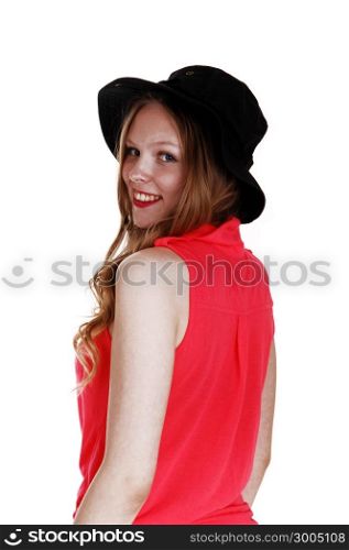 A lovely teen girl standing in a pink blouse and black hat from the back,isolated for white background.