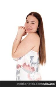 A lovely teenager girl standing in profil waist up in a pastel sommer dres swith hands folted on her face, isolated for white background