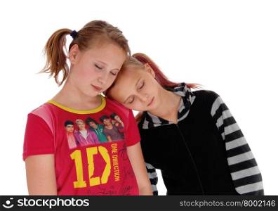 A lovely teenager girls standing and sleeping, one with there head on theshoulder of the other, isolated for white background.